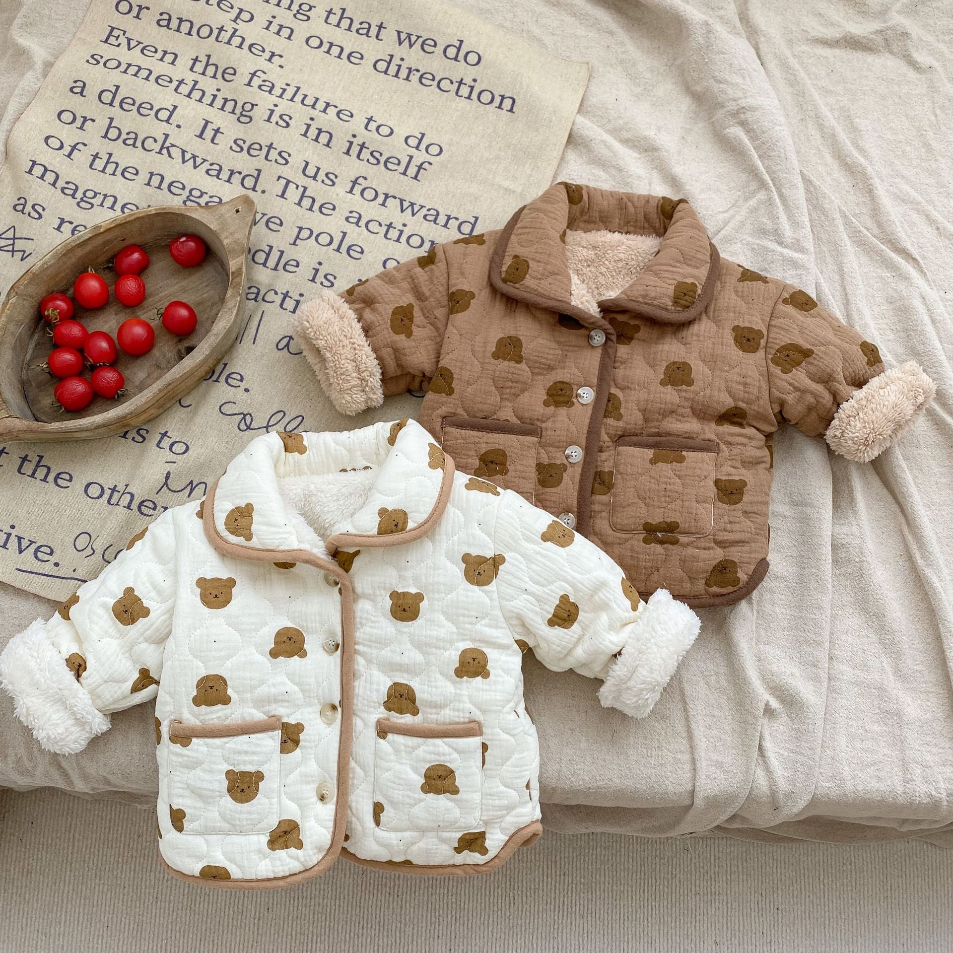 A cozy baby girl quilted cotton coat featuring an all-over bear graphic in white and brown colors, perfect for chilly weather.