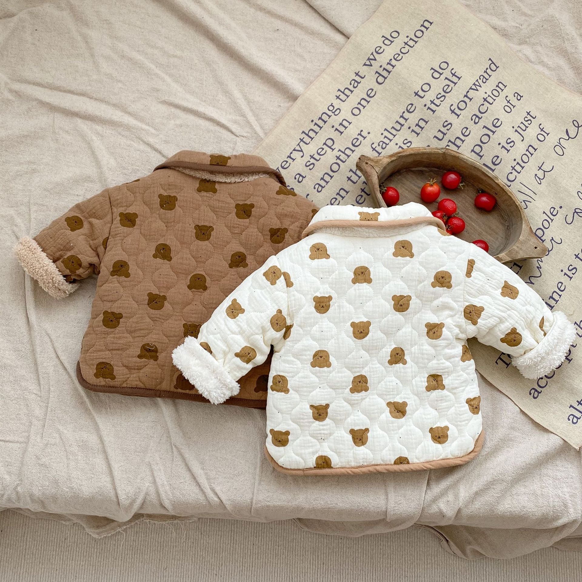 A cozy baby girl quilted cotton coat featuring an all-over bear graphic in white and brown colors, perfect for chilly weather.