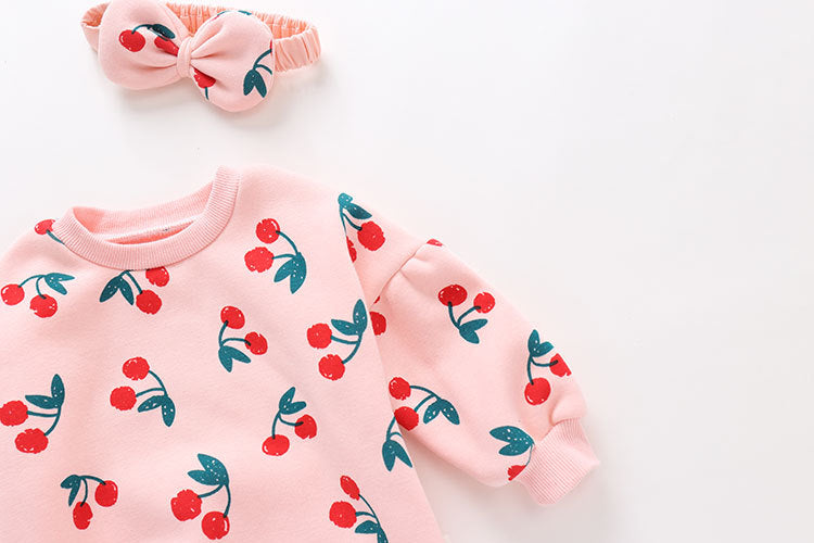 Baby girl bodysuit featuring an allover cherry pattern with lantern sleeves in pink cotton fabric.