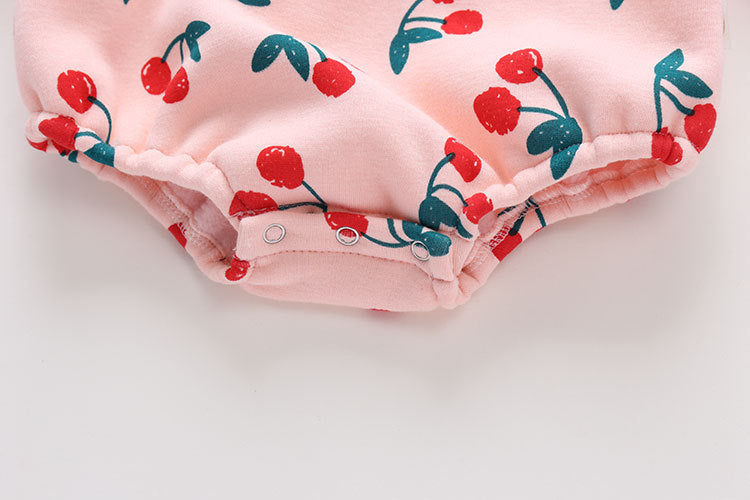 Baby girl bodysuit featuring an allover cherry pattern with lantern sleeves in pink cotton fabric.