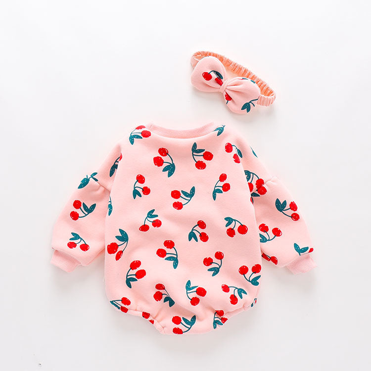 Baby girl bodysuit featuring an allover cherry pattern with lantern sleeves in pink cotton fabric.