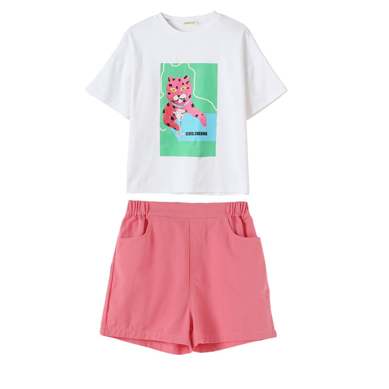 Baby girl wearing a stylish animal print t-shirt and denim shorts, perfect for summer adventures.