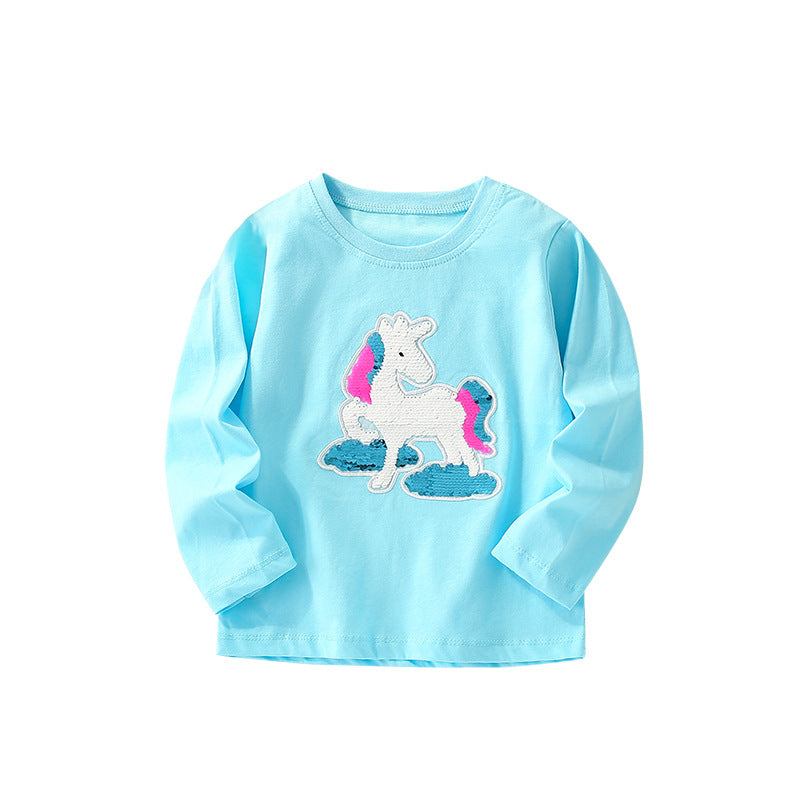 Baby girl wearing a colorful cartoon pattern crewneck shirt, showcasing vibrant colors and playful designs.