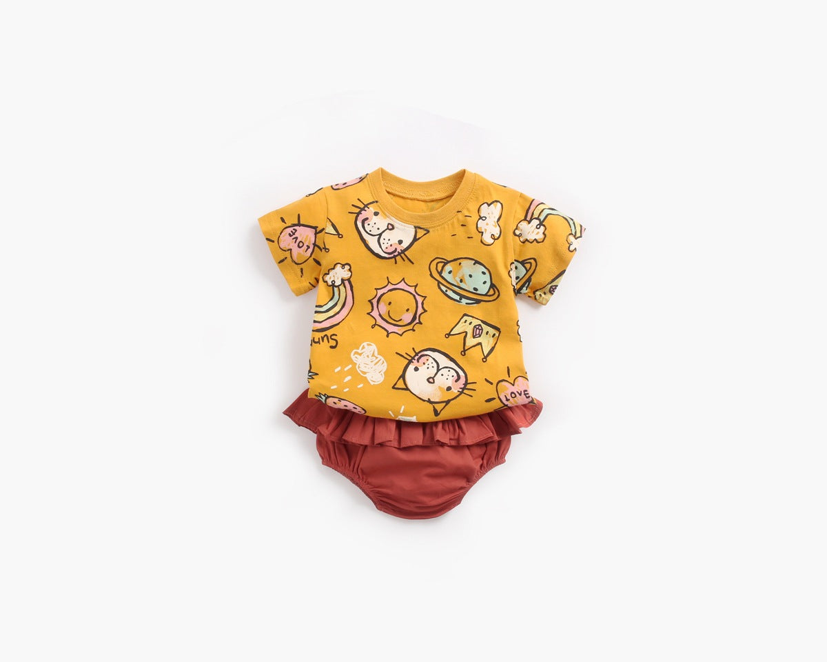 Baby girl wearing a yellow cartoon print O-neck T-shirt and ruffle shorts set, showcasing a playful summer style.