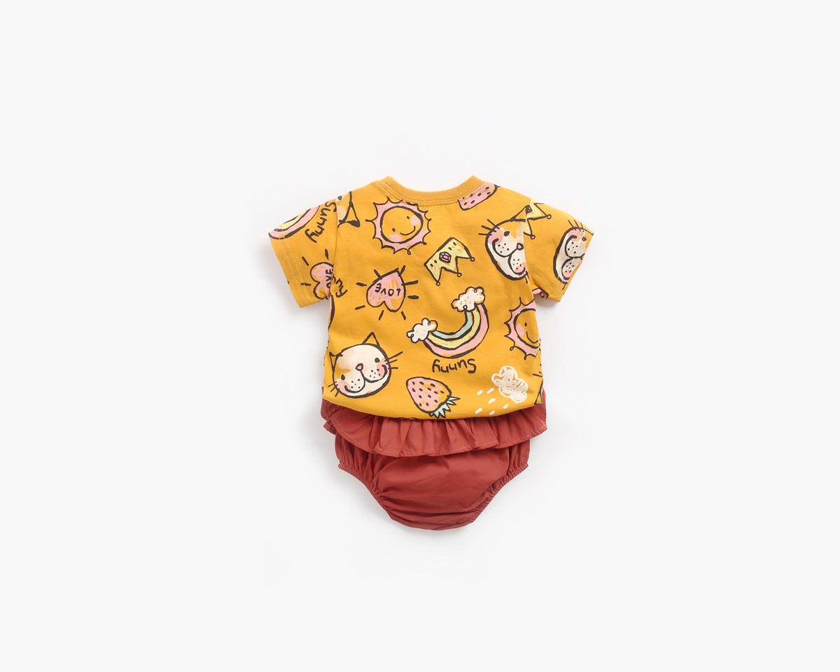 Baby girl wearing a yellow cartoon print O-neck T-shirt and ruffle shorts set, showcasing a playful summer style.