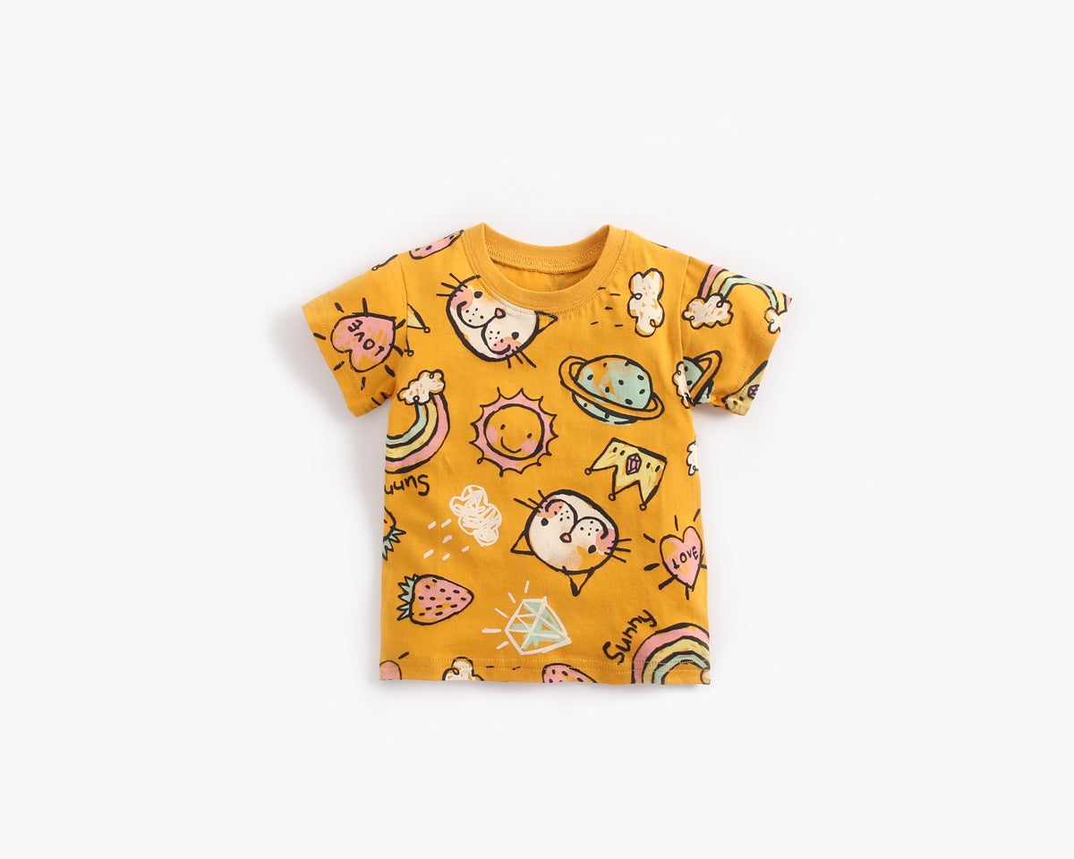 Baby girl wearing a yellow cartoon print O-neck T-shirt and ruffle shorts set, showcasing a playful summer style.