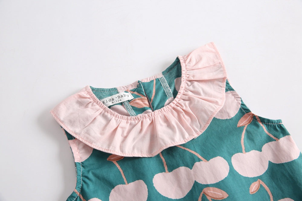 Baby girl wearing a cherry print ruffle design O-neck top and shorts set, perfect for summer outings.