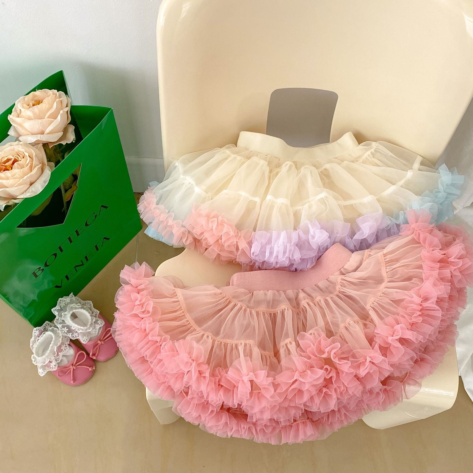 A colorful tutu skirt for baby girls in white and pink, made from breathable cotton, perfect for summer wear.