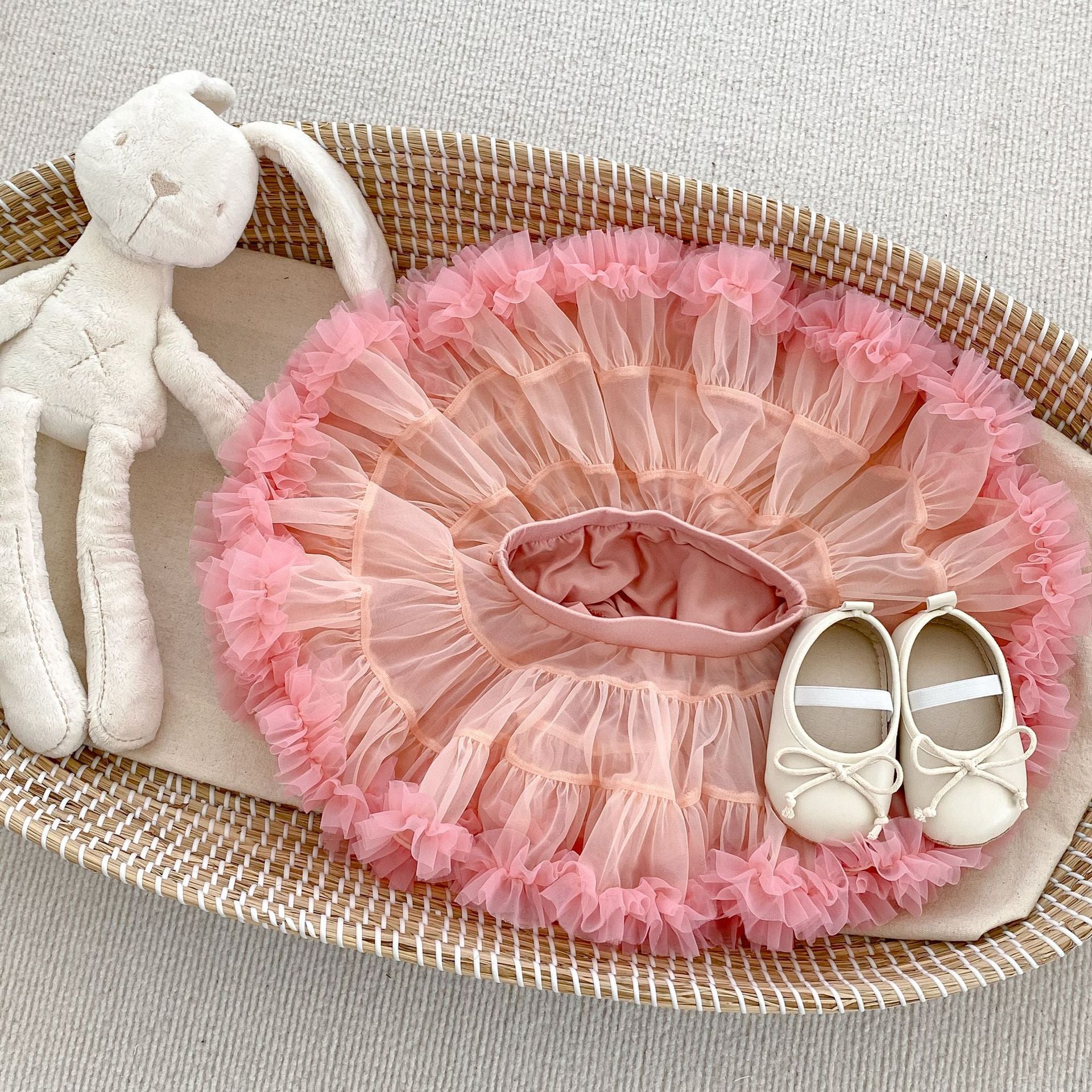 A colorful tutu skirt for baby girls in white and pink, made from breathable cotton, perfect for summer wear.