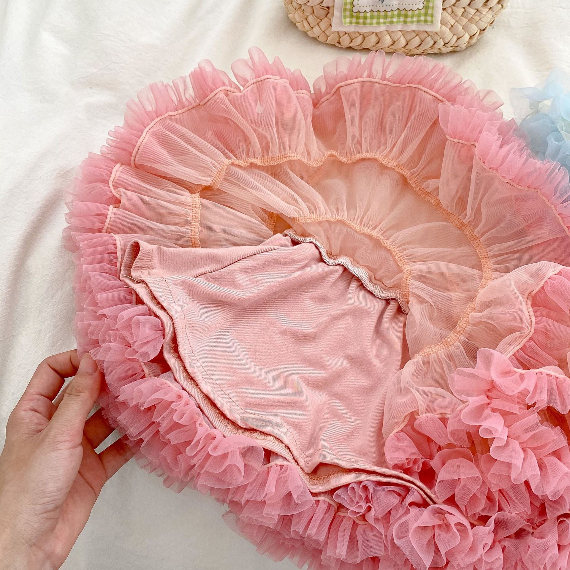 A colorful tutu skirt for baby girls in white and pink, made from breathable cotton, perfect for summer wear.