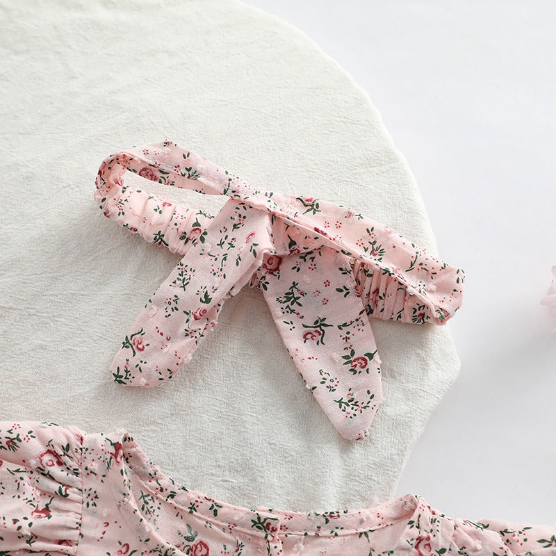 Baby girl long sleeve bodysuit featuring a ditsy flower pattern in soft pink, perfect for spring and autumn wear.