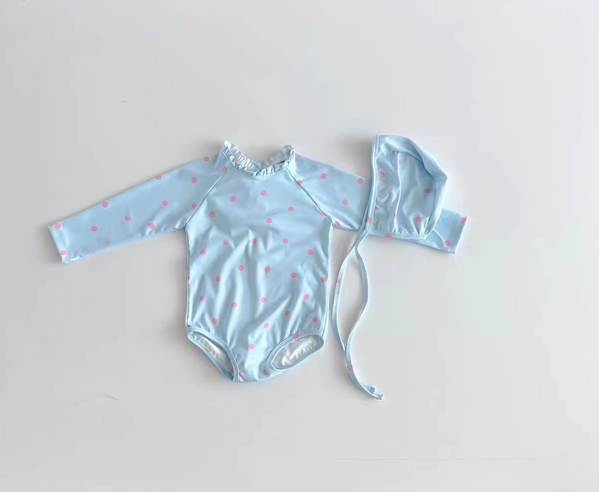 Baby girl wearing a long sleeve onesie with a ditsy flower pattern and a matching hat, showcasing the white and blue color options.