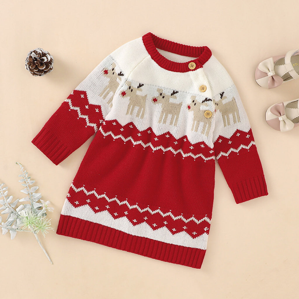 A beautiful baby girl wearing a long sleeve embroidered Christmas dress in red with a cartoon pattern, perfect for autumn occasions.