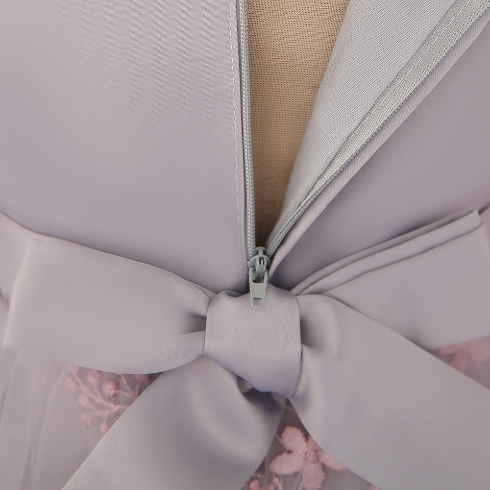 Baby girl wearing an elegant embroidered pattern tutu formal dress with medium sleeves in pink color.