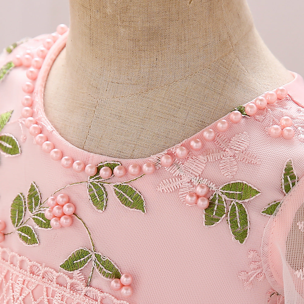 Baby girl wearing an elegant embroidered pattern tutu formal dress with medium sleeves in pink color.