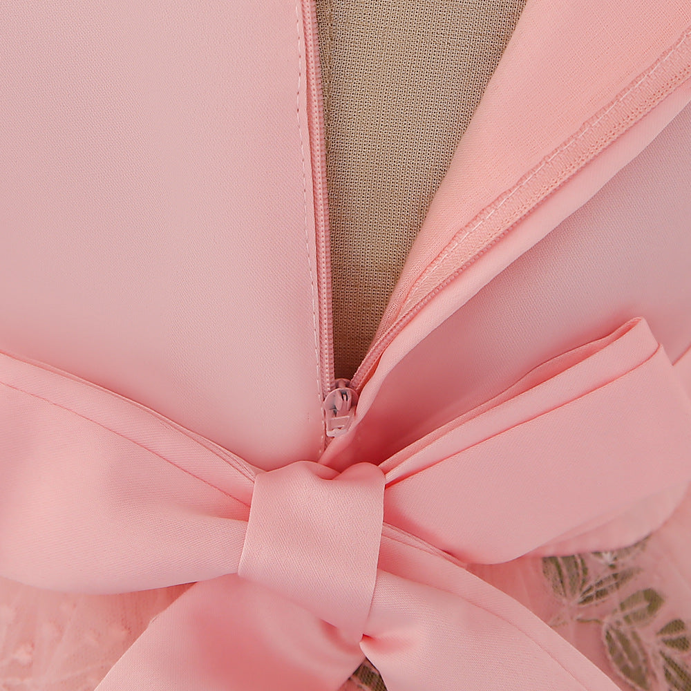 Baby girl wearing an elegant embroidered pattern tutu formal dress with medium sleeves in pink color.