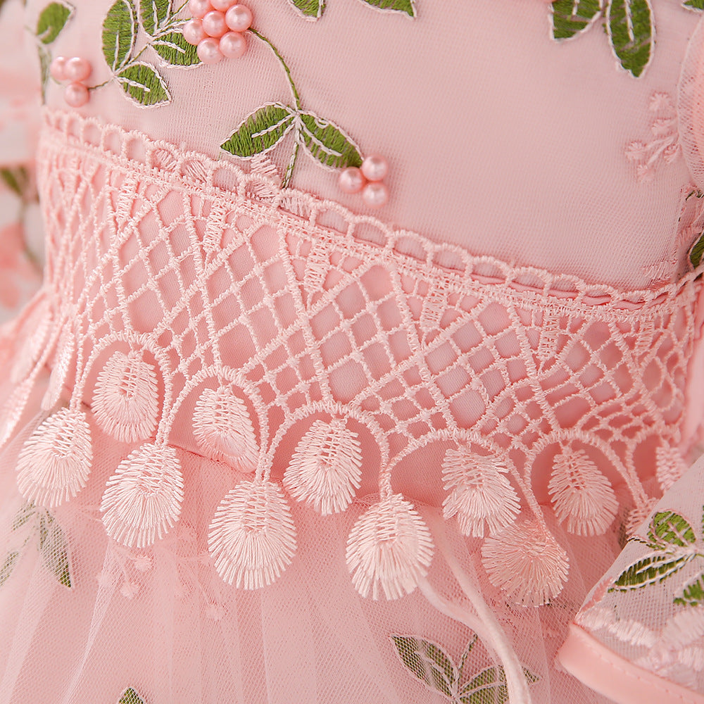 Baby girl wearing an elegant embroidered pattern tutu formal dress with medium sleeves in pink color.