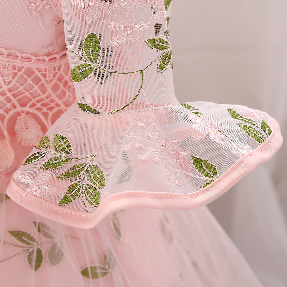 Baby girl wearing an elegant embroidered pattern tutu formal dress with medium sleeves in pink color.