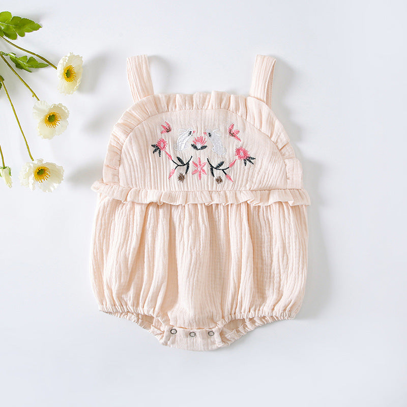 Baby girl wearing a floral embroidered sleeveless onesie in pink, showcasing lace design and solid color, perfect for summer.