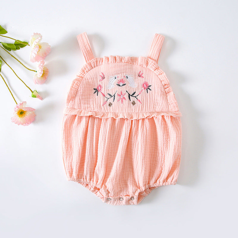 Baby girl wearing a floral embroidered sleeveless onesie in pink, showcasing lace design and solid color, perfect for summer.