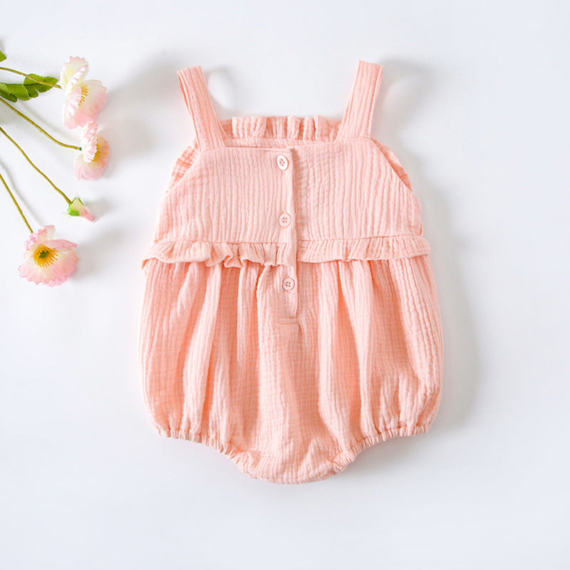 Baby girl wearing a floral embroidered sleeveless onesie in pink, showcasing lace design and solid color, perfect for summer.