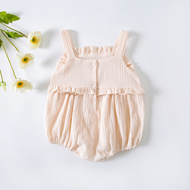 Baby girl wearing a floral embroidered sleeveless onesie in pink, showcasing lace design and solid color, perfect for summer.