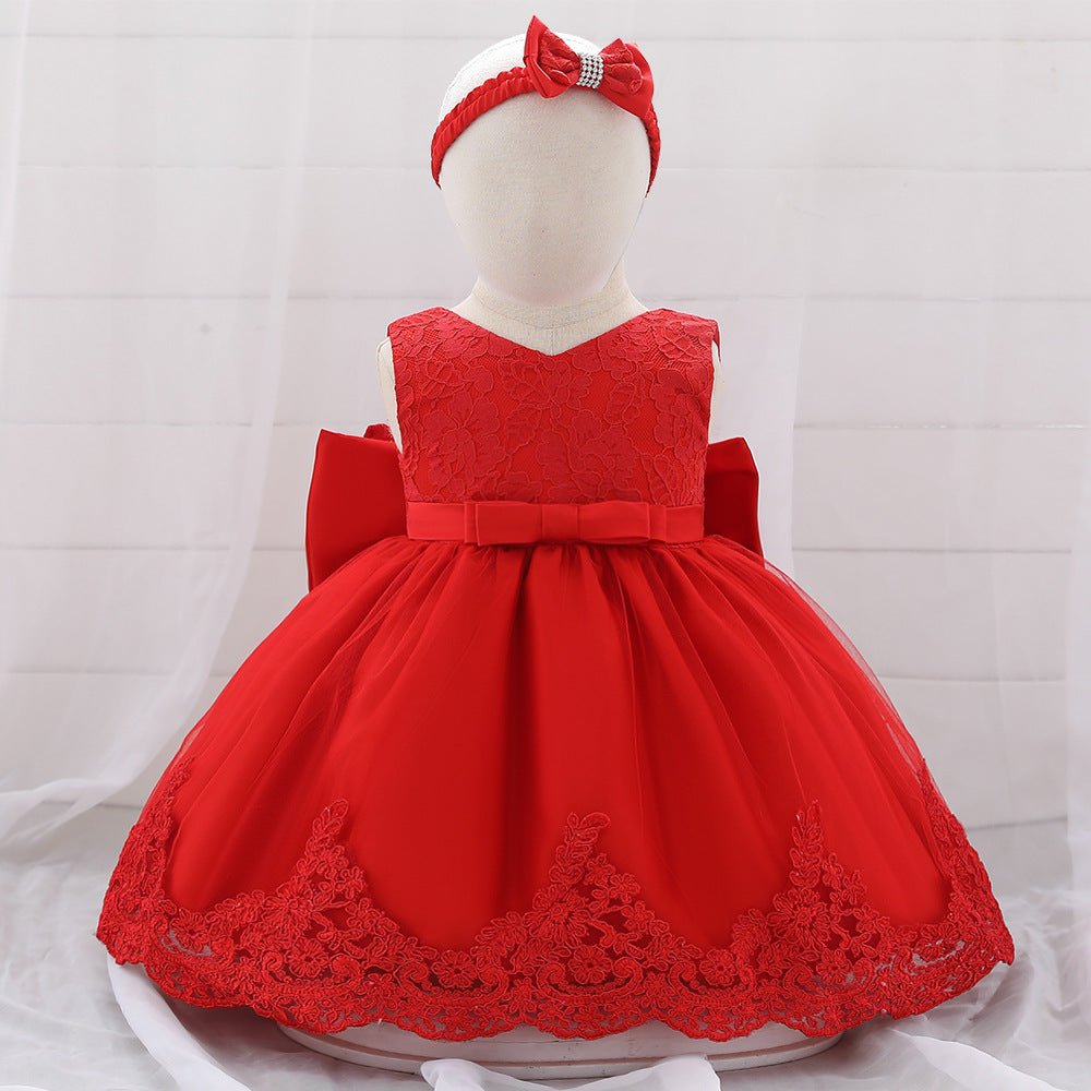 Baby girl wearing a floral mesh overlay formal dress with matching headband, perfect for special occasions.