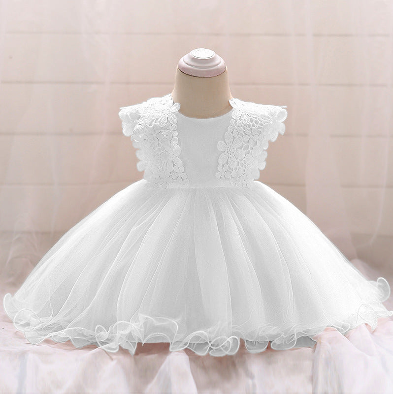 Baby girl wearing a floral patched graphic mesh tutu dress in white and pink, perfect for birthdays and baptisms.