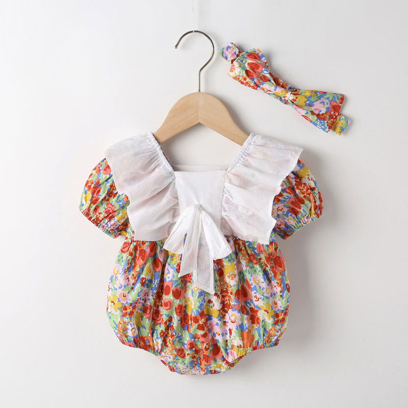 Baby girl onesie featuring a floral pattern, white bow patchwork, and square neckline, perfect for summer wear.