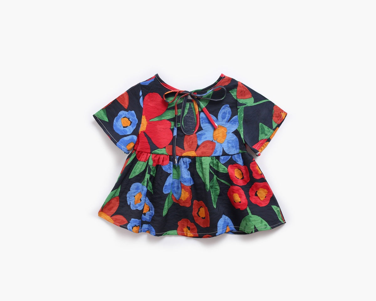 Adorable baby girl wearing a floral print O-neck T-shirt and matching trousers set, showcasing vibrant colors and a stylish design.