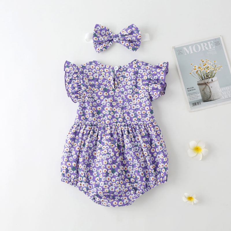 Baby girl wearing a floral print onesie with a matching headband, perfect for summer outings.