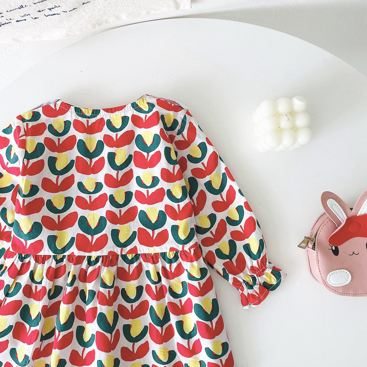 A beautiful baby girl dress featuring a floral print pattern with a doll neck and A-line design, available in red and green colors.