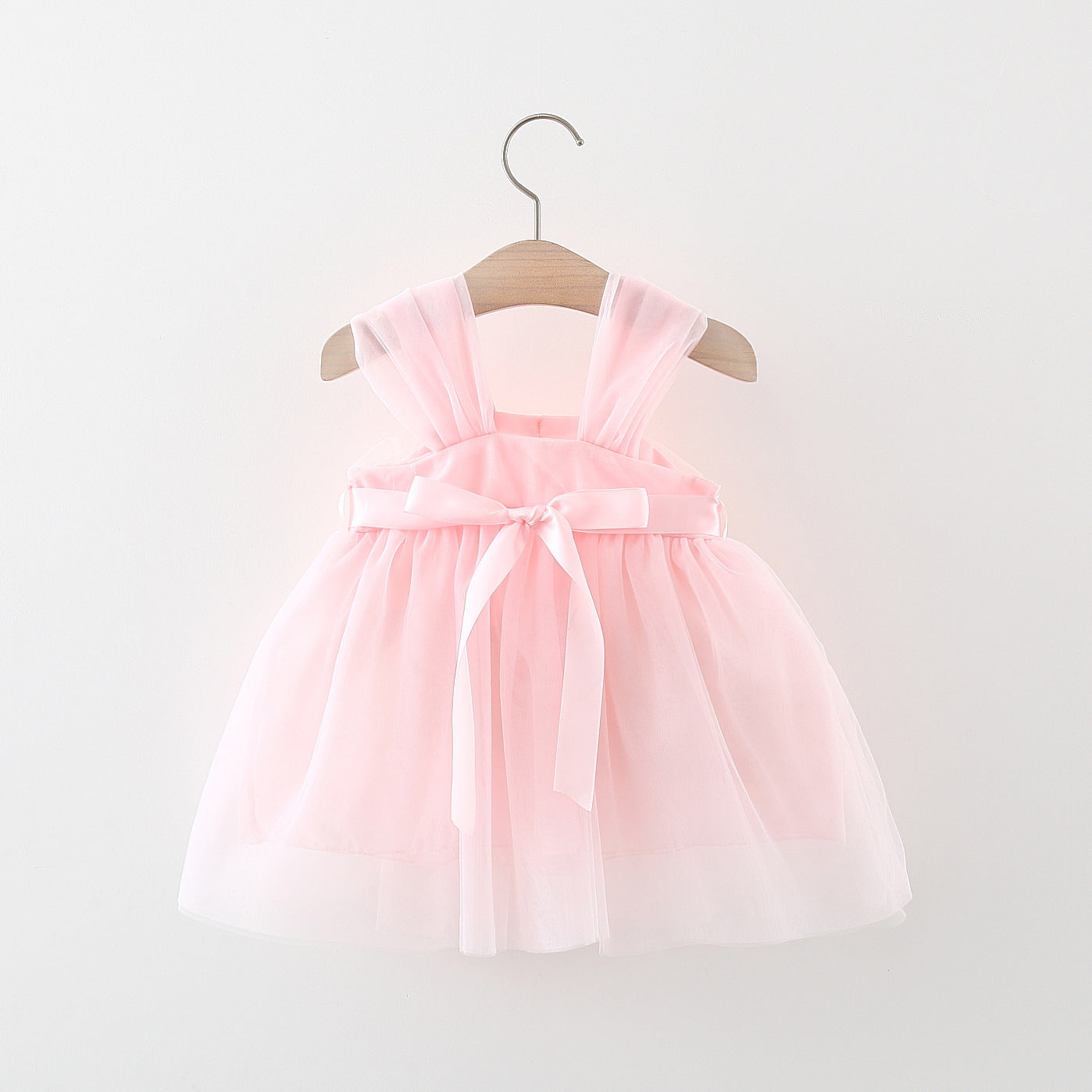 A beautiful baby girl wearing a flower patched design mesh princess formal dress in pink, showcasing delicate floral details and an elegant style.