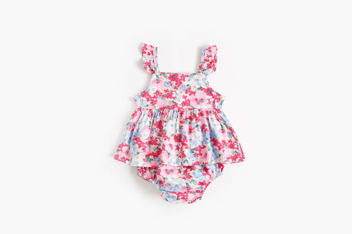 Baby girl outfit featuring a floral pattern sling top and matching shorts in pink, blue, and yellow colors.