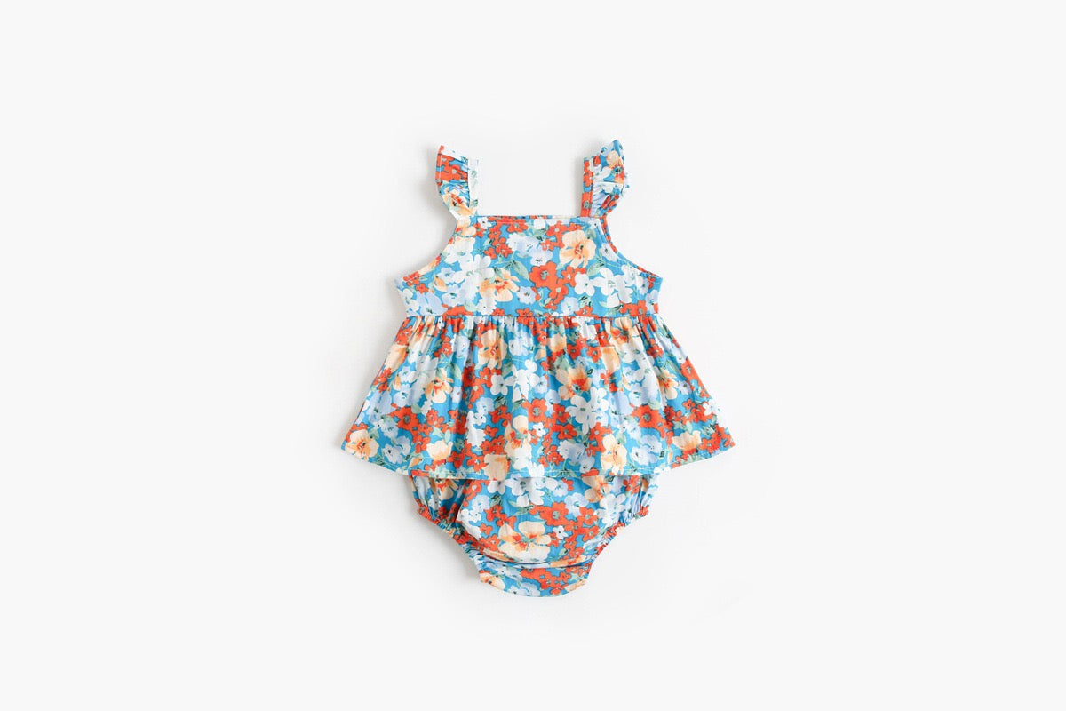 Baby girl outfit featuring a floral pattern sling top and matching shorts in pink, blue, and yellow colors.