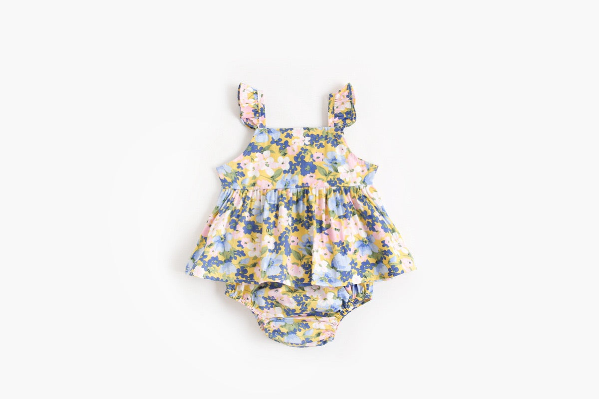 Baby girl outfit featuring a floral pattern sling top and matching shorts in pink, blue, and yellow colors.