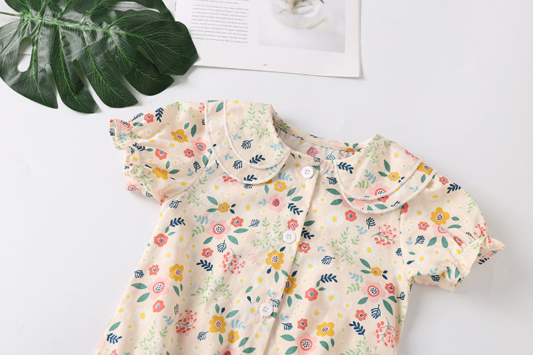 A stylish baby girl shirt featuring a floral print and double collar design, perfect for summer wear.