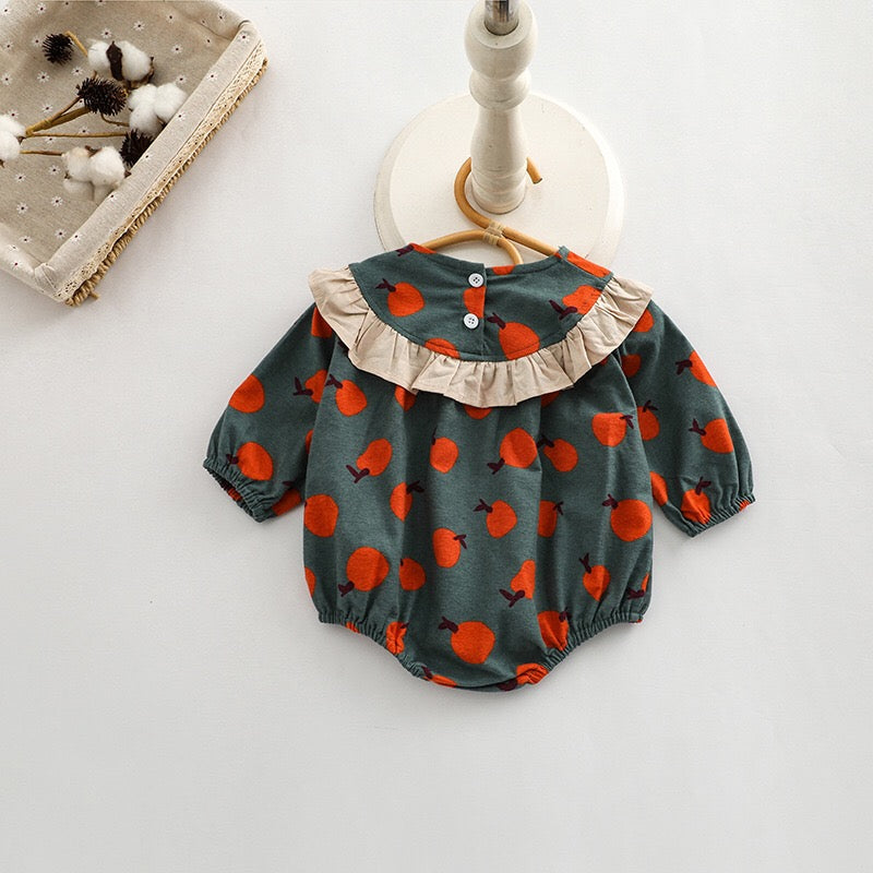 Baby girl long sleeve onesies featuring a vibrant fruit orange patchwork design in pink, green, and yellow colors.