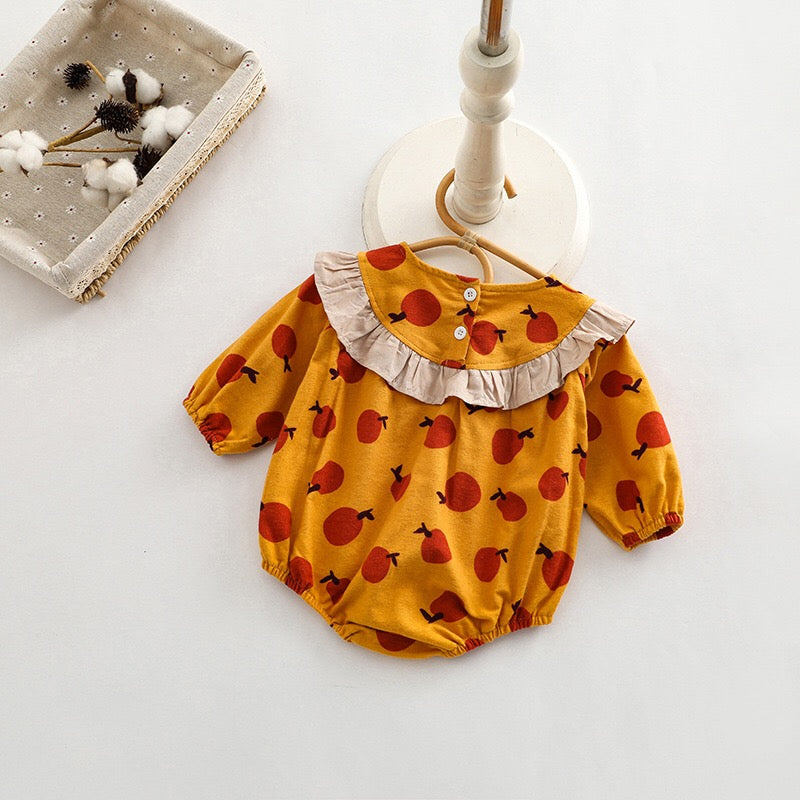 Baby girl long sleeve onesies featuring a vibrant fruit orange patchwork design in pink, green, and yellow colors.