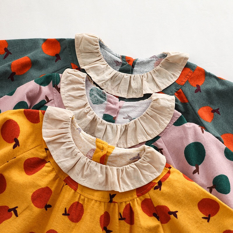 Baby girl long sleeve onesies featuring a vibrant fruit orange patchwork design in pink, green, and yellow colors.