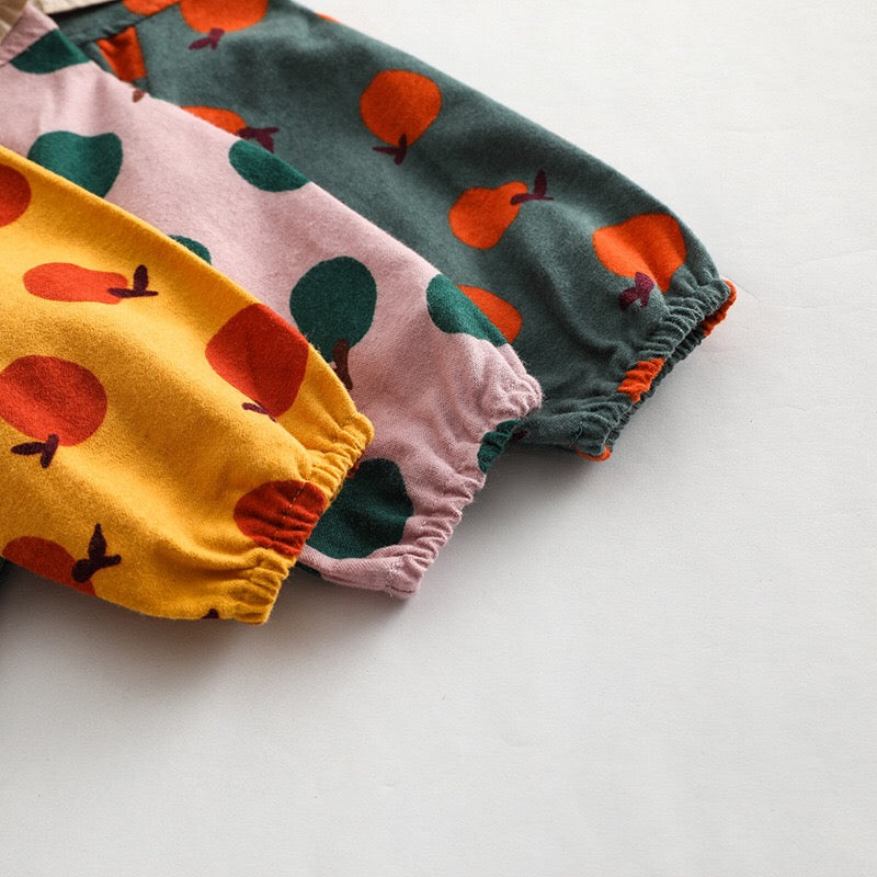 Baby girl long sleeve onesies featuring a vibrant fruit orange patchwork design in pink, green, and yellow colors.