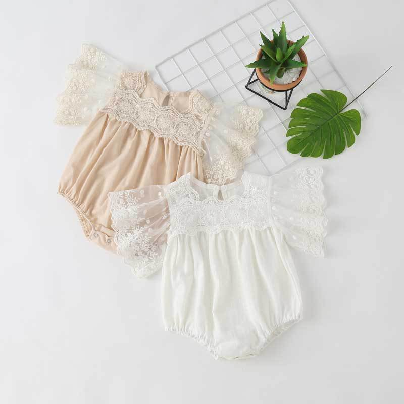 Baby girl lace-sleeved onesie in white and apricot colors, featuring delicate lace sleeves and collar, perfect for summer occasions.