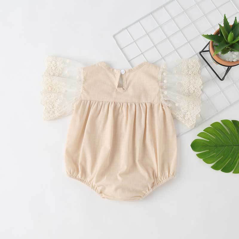 Baby girl lace-sleeved onesie in white and apricot colors, featuring delicate lace sleeves and collar, perfect for summer occasions.