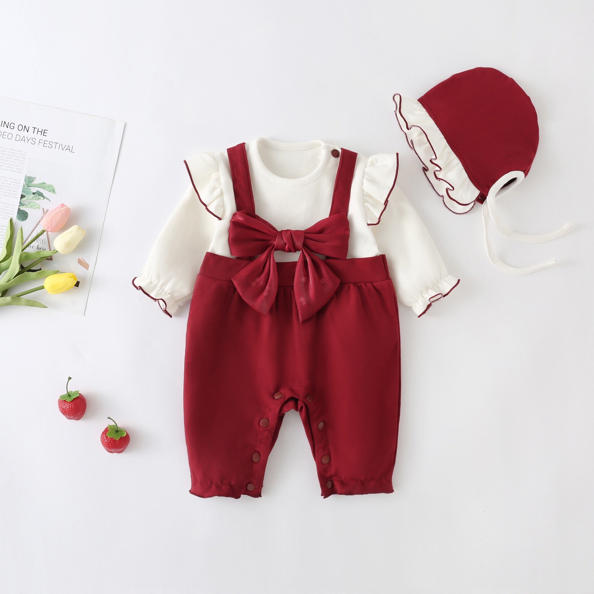 A stylish Baby Girl Lettuce Trim Design Big Bow Long Sleeve Jumpsuit in vibrant red, featuring a chic big bow and playful lettuce trim.