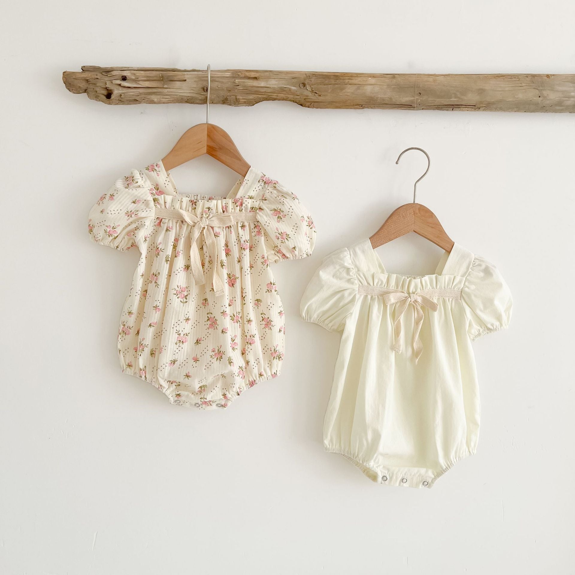 Baby girl onesie featuring a lovely bow-tie design, short sleeves, available in beige and apricot colors.