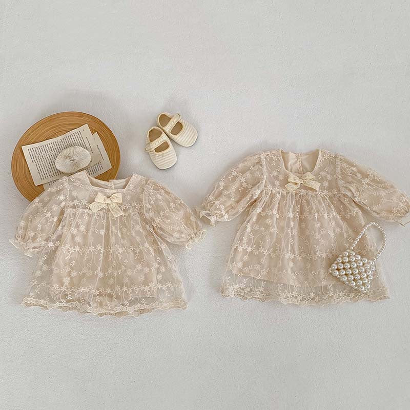 Baby girl mesh patched design square neck onesies dress in beige and apricot colors, featuring floral and embroidered patterns.