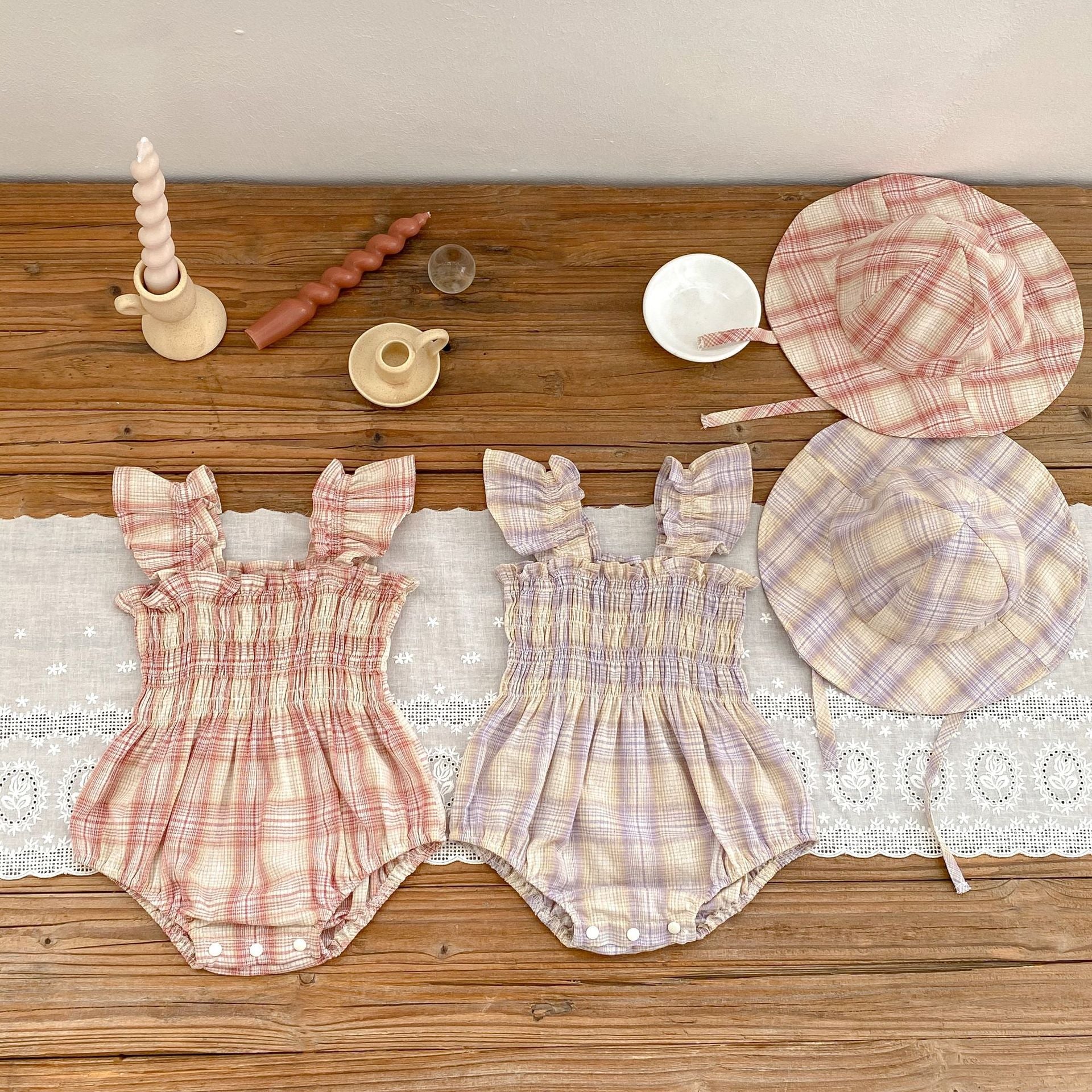 Baby girl plaid pattern onesie with flying sleeves and matching hat in pink and purple colors.