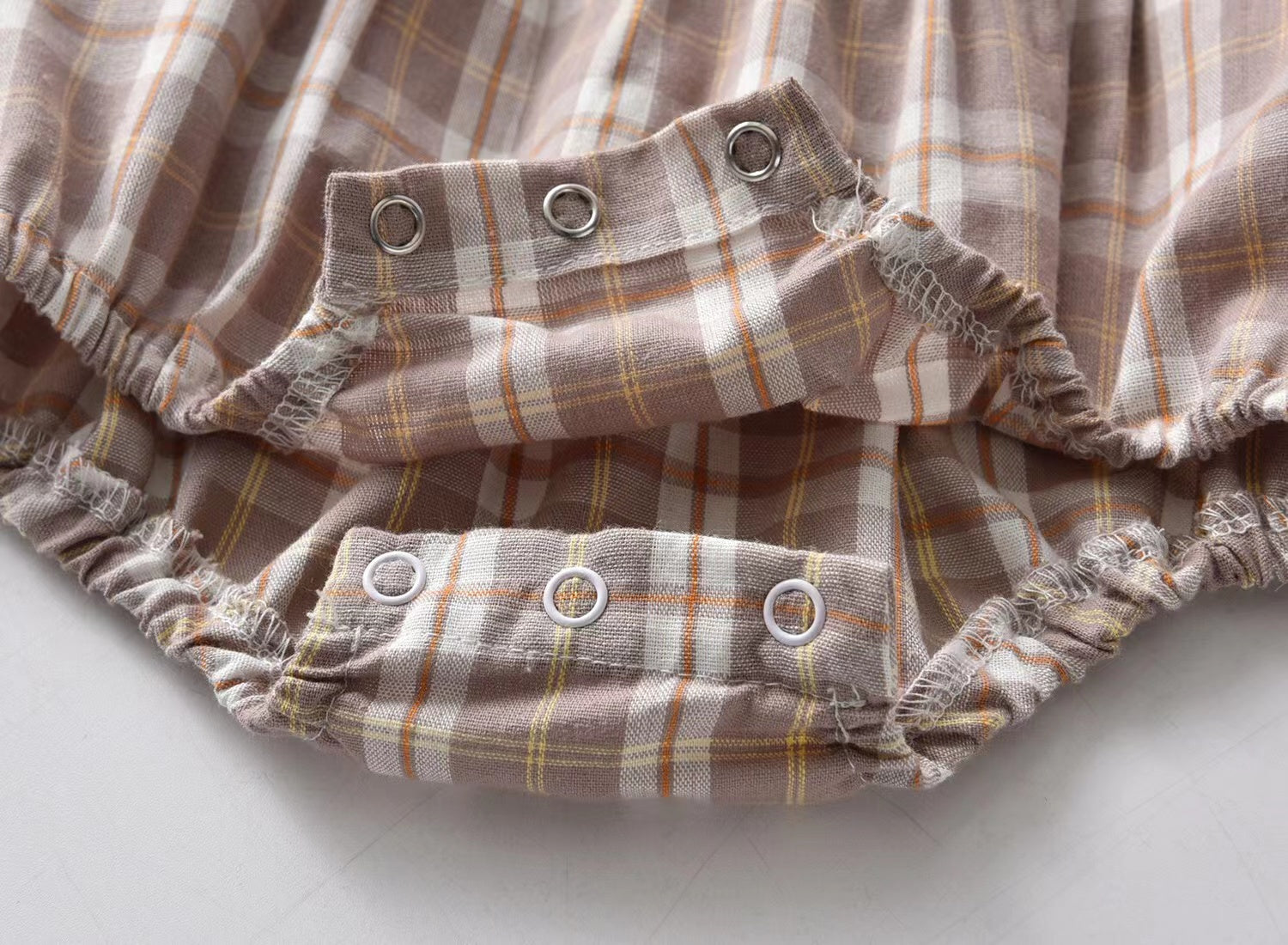 Baby girl plaid pattern long sleeved onesie with lapel design in coffee color, perfect for cooler days.