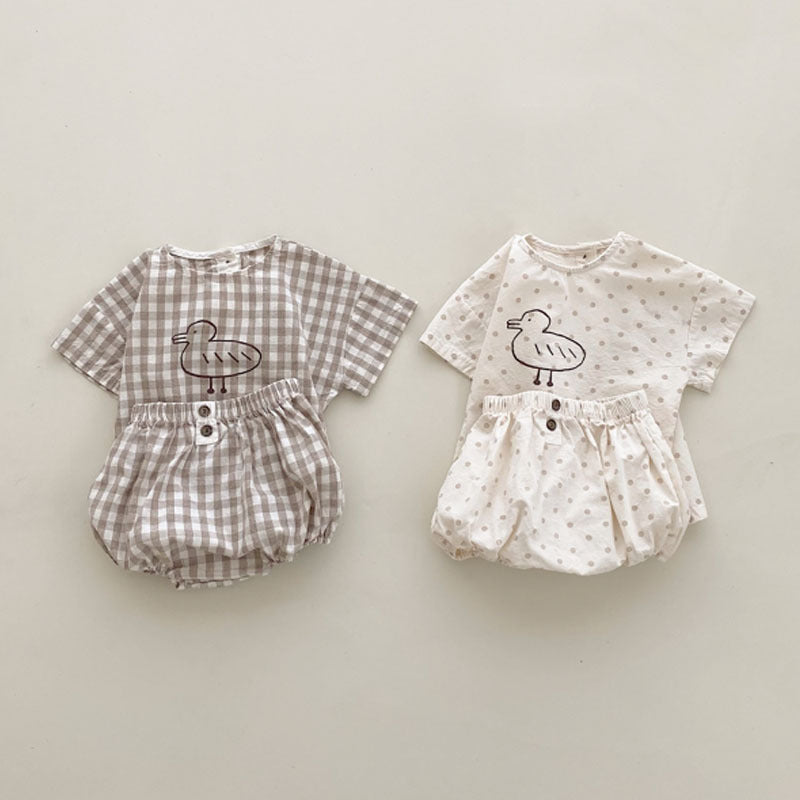 Baby girl short sleeved top featuring plaid and polka dot patterns with a cute duckling print, available in white and brown.