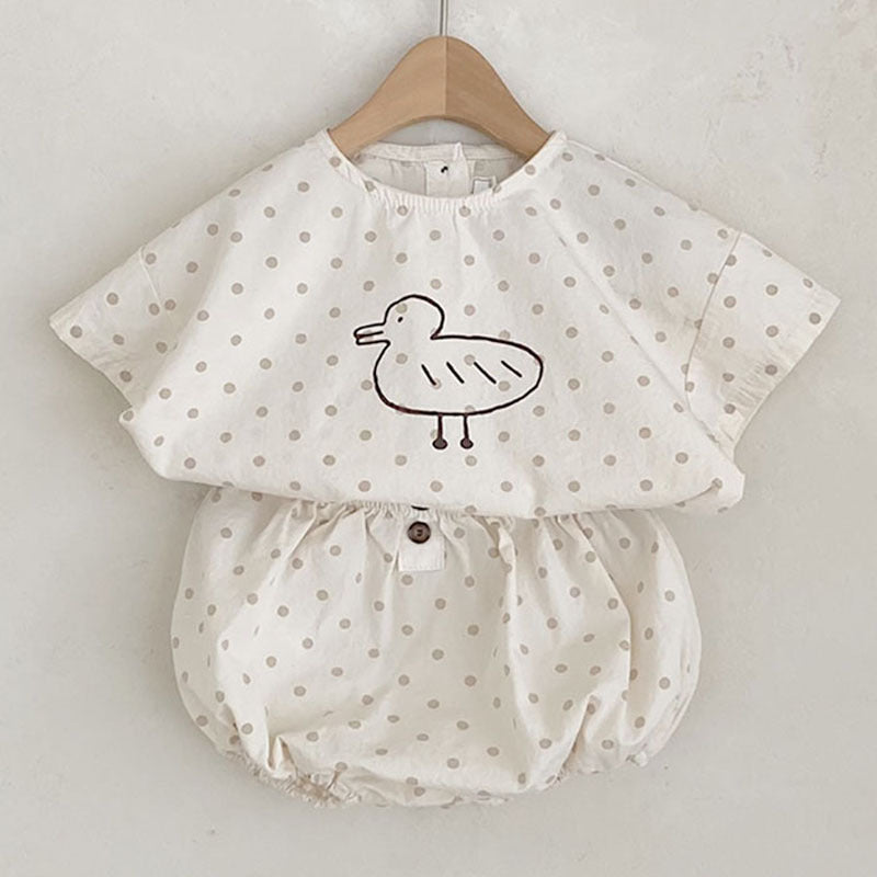 Baby girl short sleeved top featuring plaid and polka dot patterns with a cute duckling print, available in white and brown.